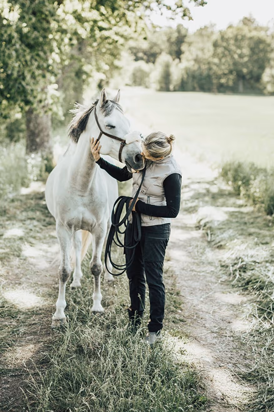 trainer checking the horse